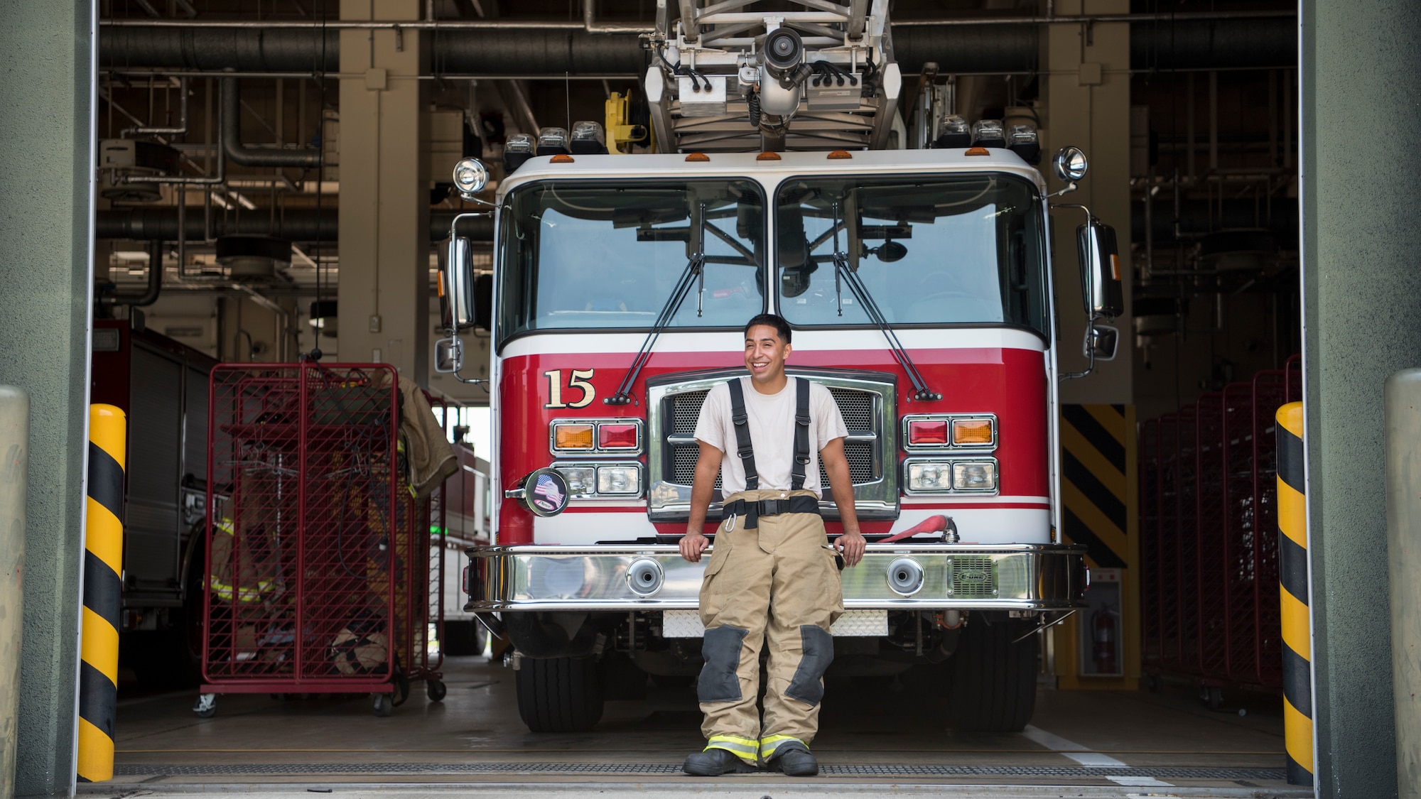 U.S. Air Force Airman 1st Class Adam Cardona, a 35th Civil Engineer fire protection journeyman, pauses for a photo in front of a fire truck at Misawa Air Base, Japan, Aug. 7, 2019. Cardona’s leadership makes training exercises a top priority due to the base’s location, enhancing his professional growth. (U.S. Air Force photo by Senior Airman Collette Brooks)