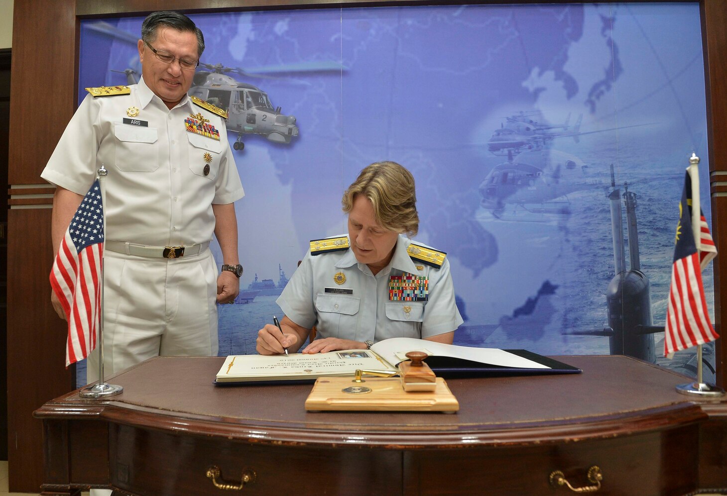LUMUT, Malaysia (Aug 14, 2019) The Pacific Area commander for the U.S. Coast Guard, Vice Adm. Linda Fagan, signs the guest book at Western Fleet Headquarters next to Vice Adm. Dato’ Aris Adi Tan Bin Abdullah, commander of Royal Malaysian Navy Western Fleet as part of Maritime Training Activity (MTA) Malaysia 2019 opening ceremony at Lumut Naval Base. MTA Malaysia 2019 is a continuation of 25 years of maritime engagements between the U.S. Navy and Royal Malaysian Navy serving to enhance mutual capabilities in ensuring maritime security and stability.