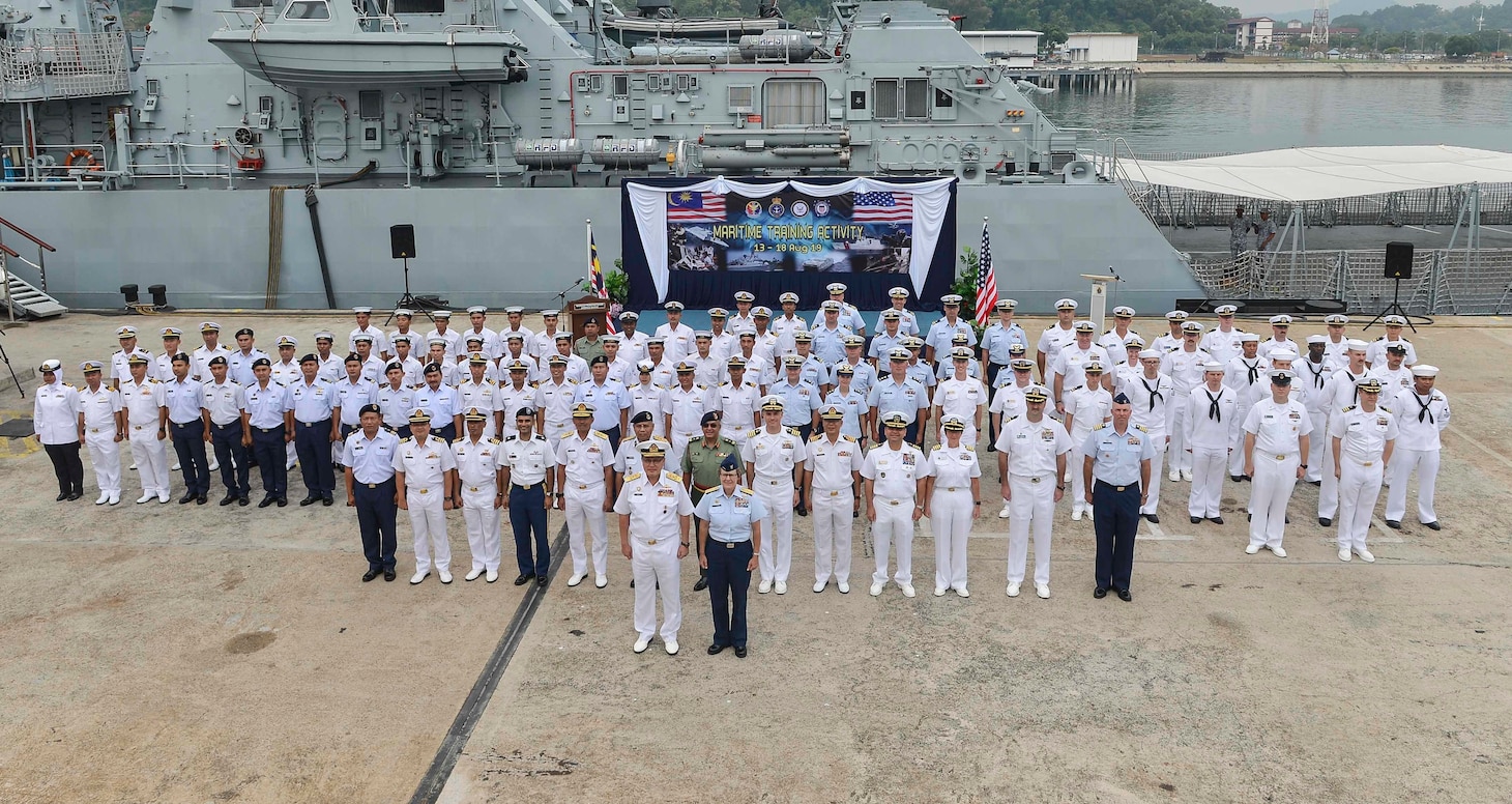 LUMUT, Malaysia (Aug 14, 2019) The Pacific Area commander for the U.S. Coast Guard, Vice Adm. Linda Fagan, stands next to Vice Adm. Dato’ Aris Adi Tan Bin Abdullah, commander of Royal Malaysian Navy Western Fleet in front of U.S. Navy Sailors and Coast Guardsmen and their Malaysian counterparts as part of Maritime Training Activity (MTA) Malaysia 2019 opening ceremony at Lumut Naval Base. MTA Malaysia 2019 is a continuation of 25 years of maritime engagements between the U.S. Navy and Royal Malaysian Navy serving to enhance mutual capabilities in ensuring maritime security and stability.