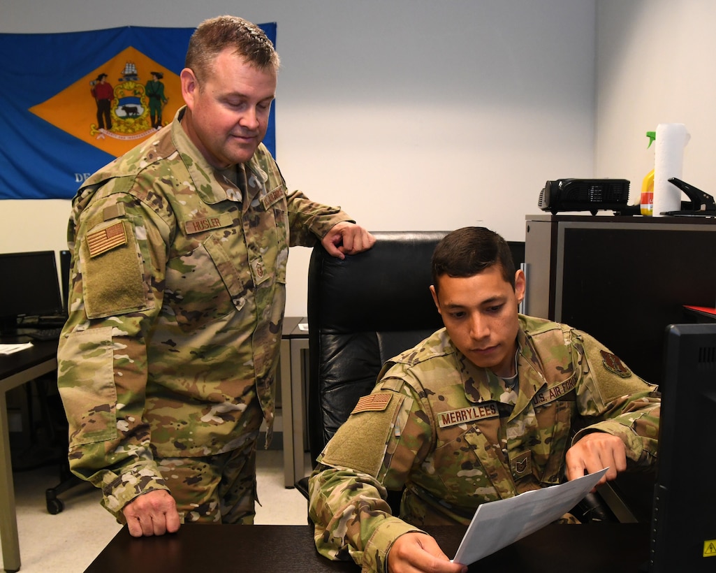U.S. Air Force Technical Sgt. Andrew C. Merrylees, a radio frequency transmission system specialist from the 166th Airlift Wing, Delaware Air National Guard, shows a fellow Airman a computer program in New Castle, Delaware, June 6, 2019. Merrylees was recognized as the Air National Guard’s 2019 Outstanding Noncommissioned Officer of the Year and one of the Air Force’s 12 Outstanding Airmen of the Year for his innovative ideas in how to improve ANG cyberspace. (U.S. Air National Guard photo by Master Sgt. David J. Fenner)
