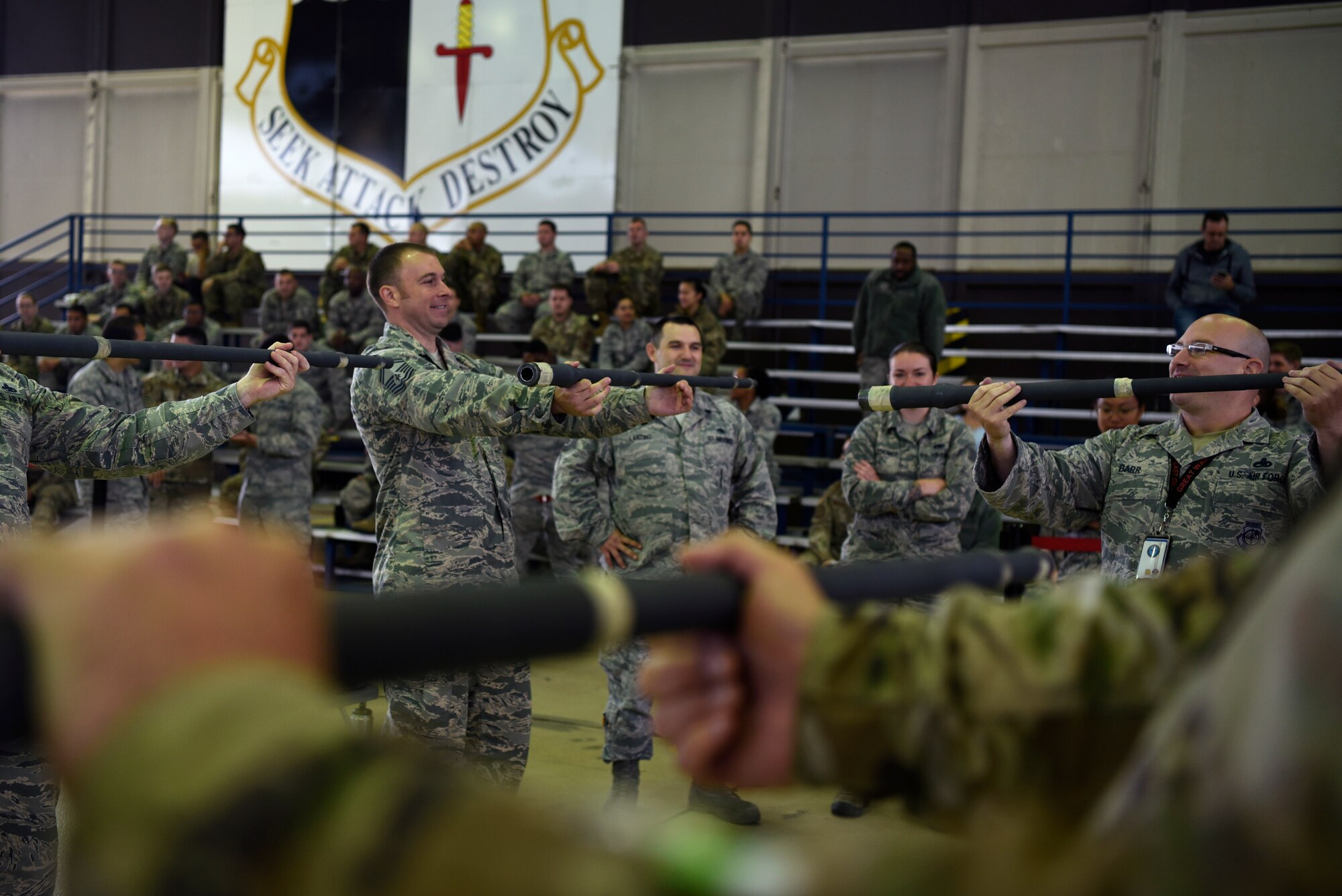 U.S. Air Force 52nd Maintenance Group Airmen participate in a "guns with guns" game during the second annual 52nd MXG Olympics at Spangdahlem Air Base, Germany, Aug. 15, 2019. During the morale event, Airmen rotated through various timed events and games specific to the maintenance career field. (U.S. Air Force photo by Airman 1st Class Valerie Seelye)