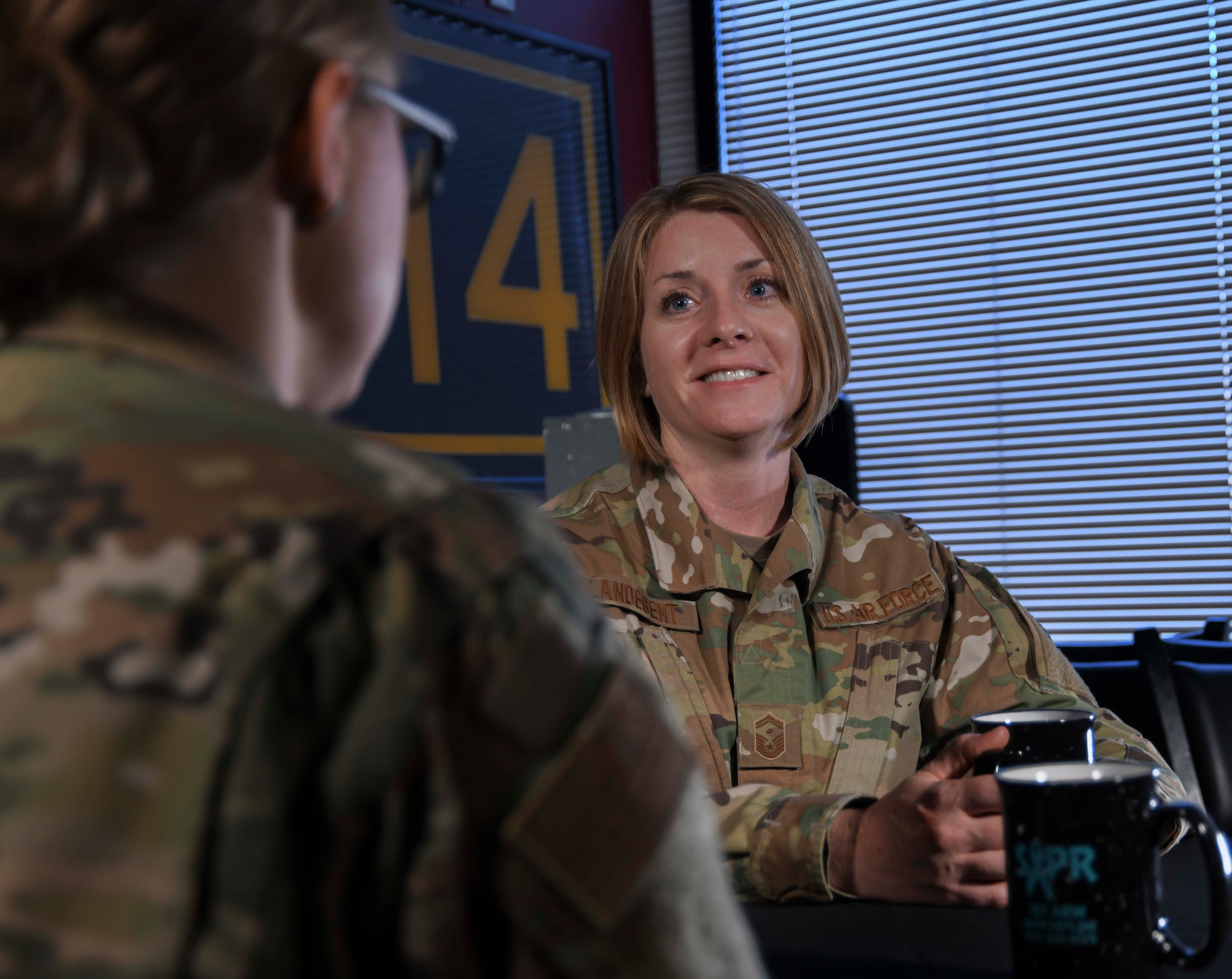 U.S. Air Force 1st Sgt. Rachel L. Landegent, the wing staff and operations group first sergeant with the 161st Air Refueling Wing, Arizona Air National Guard, listens to an Airman during a mentoring session in Phoenix, Ariz., July 2, 2019. Landegent routinely conducts one-on-one mentoring with Airmen in support of their professional and personal development. (Air National Guard photo by Staff Sgt. Morgan R. Lipinski)