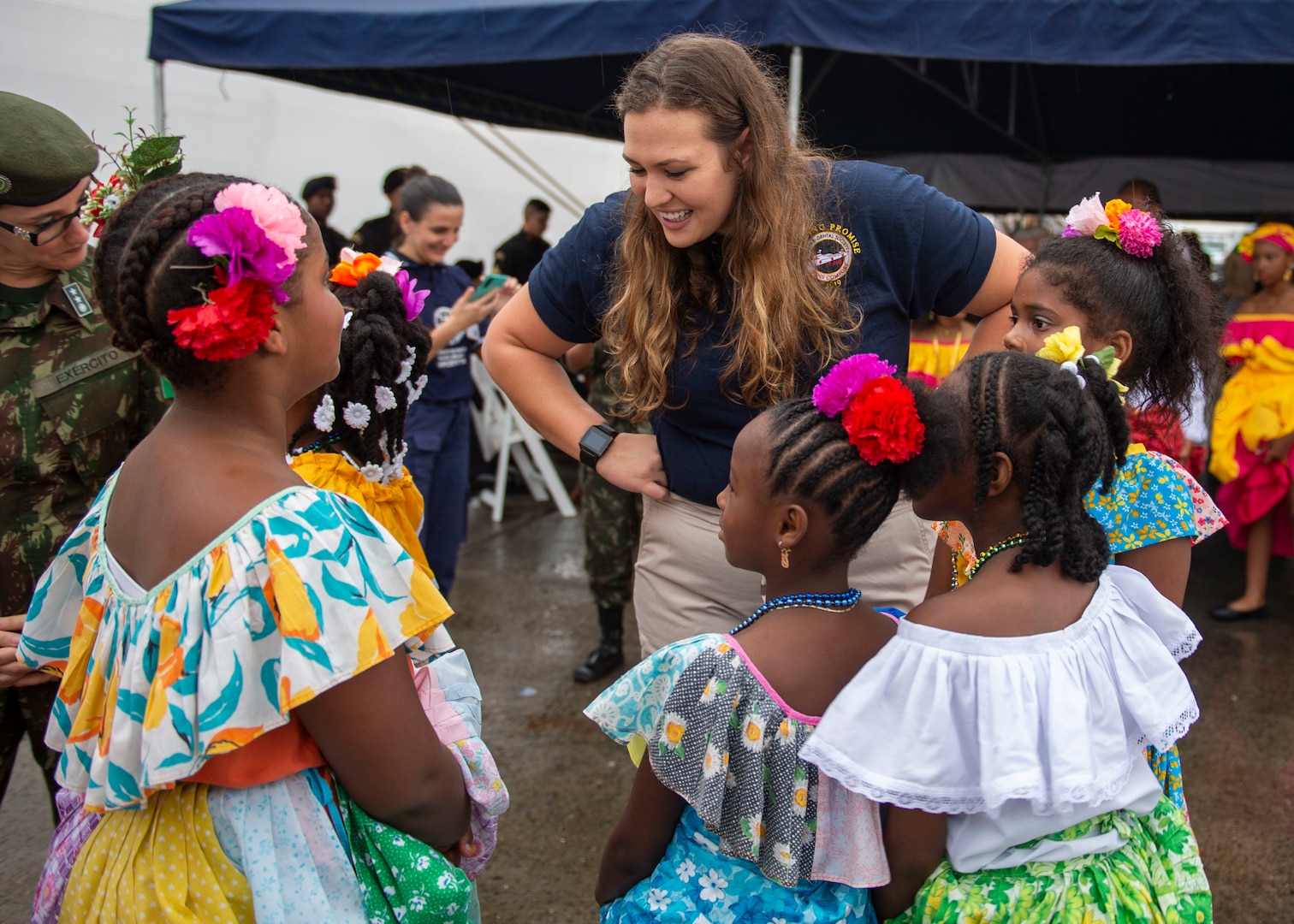 A woman talks to children.