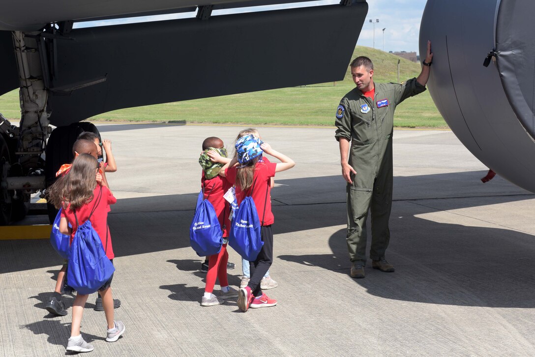 Capt. James Huff, 351st Air Refueling Squadron pilot, takes some children on a walk-around tour of a KC-135 Stratotanker during the ‘kids deployment line’ at RAF Mildenhall, England, Aug. 9, 2019. The children had the chance to take a close up look at the entire aircraft with the pilot explaining the different components. (U.S. Air Force photo by Senior Airman Benjamin Cooper)