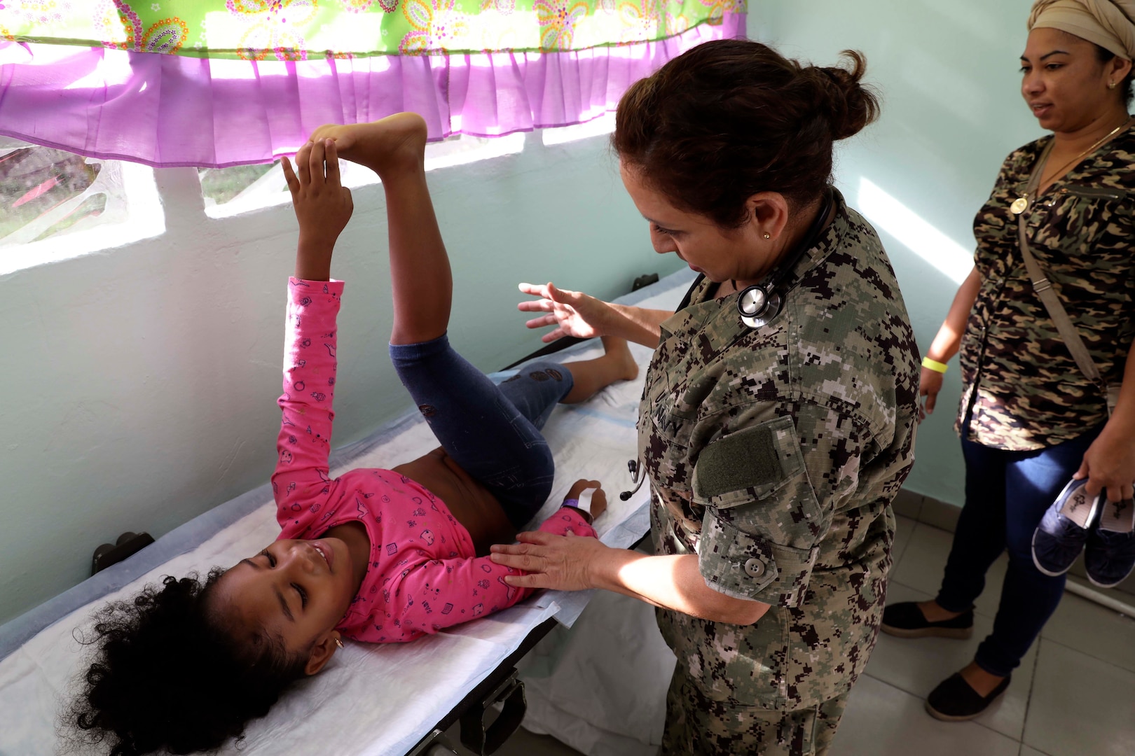 A doctor examines a girl.