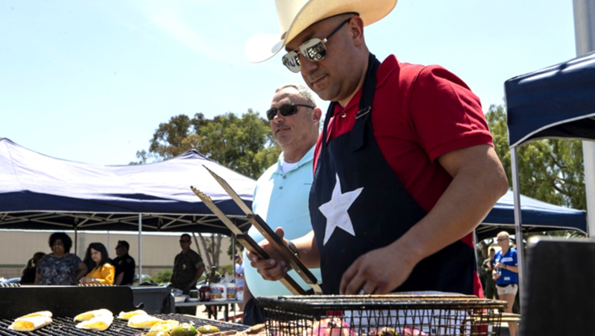 Marine Gunnery Sgt. Mario Cardenas, with Provost Marshal's Office, Headquarters and Headquarters Squadron, prepares lunch for the H&HS Barbecue Cook-off at Marine Corps Air Station Miramar, California.