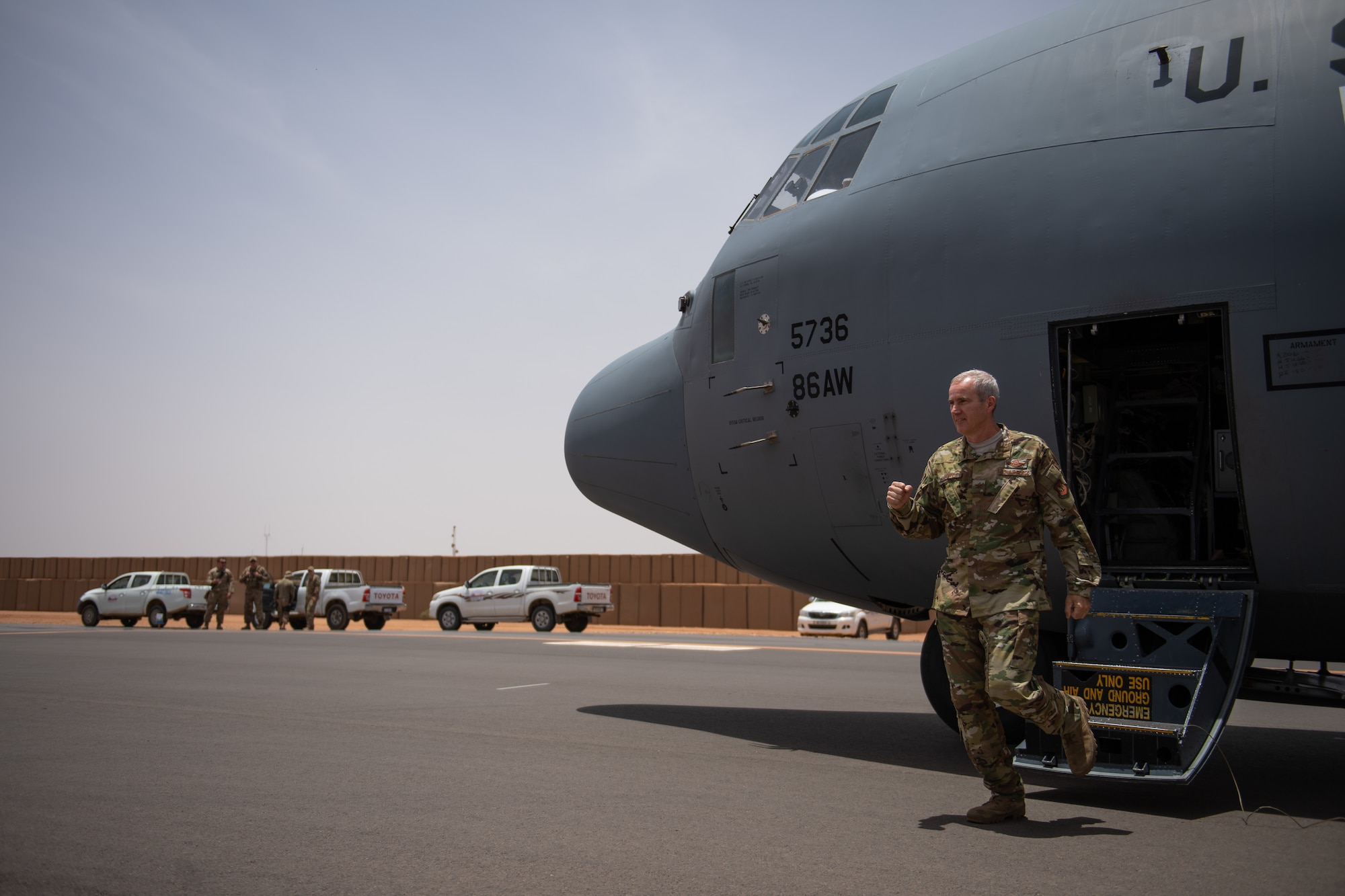 U.S. Air Force Col. Steven J. Jantz, 435th Air Ground Operations Wing and 435th Air Expeditionary Wing commander, steps out of a C-130J Super Hercules at Nigerien Air Base 201, Agadez, Niger, Aug. 3, 2019. Jantz greeted 409th Air Expeditionary Group leadership and their Airmen as the acting wing commander. The aircraft he flew in was the first C-130 to land on Air Base 201, marking the beginning of limited Visual Flight Rules operations at the base. (U.S. Air Force photo by Staff Sgt. Devin Boyer)