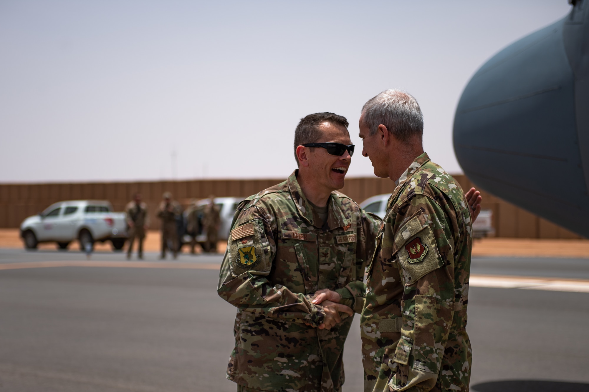 U.S. Air Force Col. Jonathan Creer, 409th Air Expeditionary Group commander, welcomes Col. Steven J. Jantz, 435th Air Ground Operations Wing and 435th Air Expeditionary Wing commander, to Nigerien Air Base 201, Agadez, Niger, Aug. 3, 2019. Jantz arrived on the first C-130 to land at Air Base 201 to congratulate the Airmen in reaching their goal of opening limited air operations at the base. (U.S. Air Force photo by Staff Sgt. Devin Boyer)