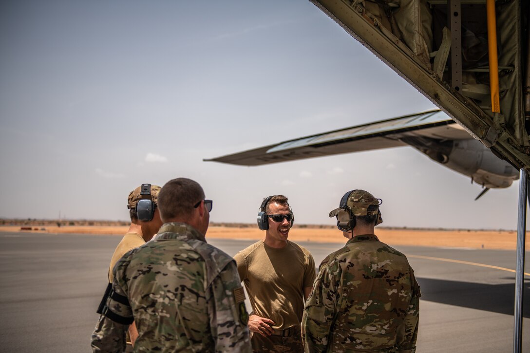 U.S. Air Force Airmen assigned to the 724th Expeditionary Air Base Squadron converse after the first military aircraft landing at Nigerien Air Base 201, Agadez, Niger, Aug. 3, 2019. The landing marked the next step in airfield evaluations by starting Visual Flight Rules operations at the base. (U.S. Air Force photo by Staff Sgt. Devin Boyer)