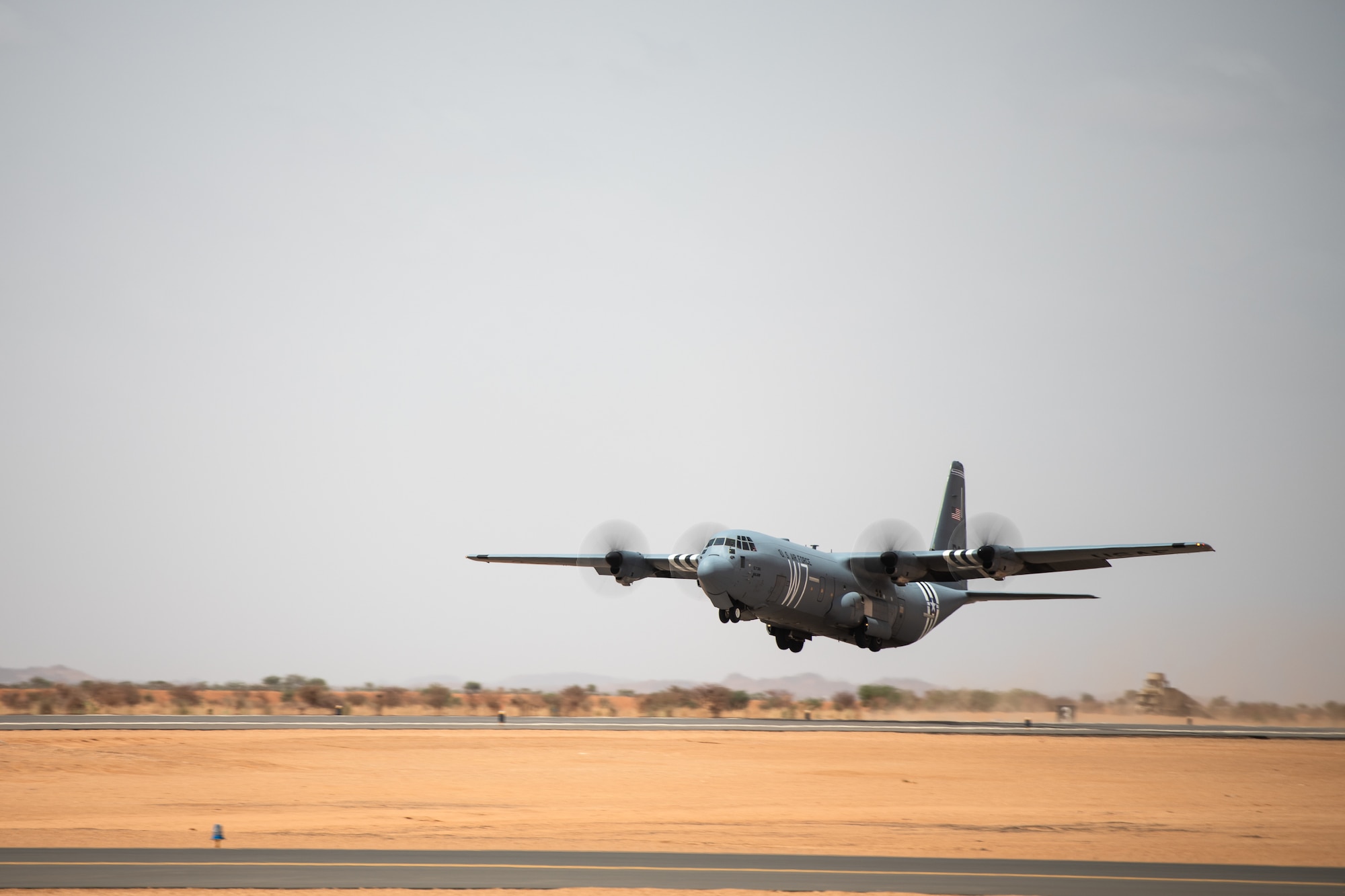 A U.S. Air Force C-130J Super Hercules assigned to the 37th Airlift Squadron at Ramstein Air Base, Germany, takes off from the new runway at Nigerien Air Base 201, Agadez, Niger, Aug. 3, 2019. The 6200-ft runway allows the Air Force to move assets in and out of Air Base 201 and is capable of supporting any aircraft up to a C-17 Globemaster III. (U.S. Air Force photo by Staff Sgt. Devin Boyer)