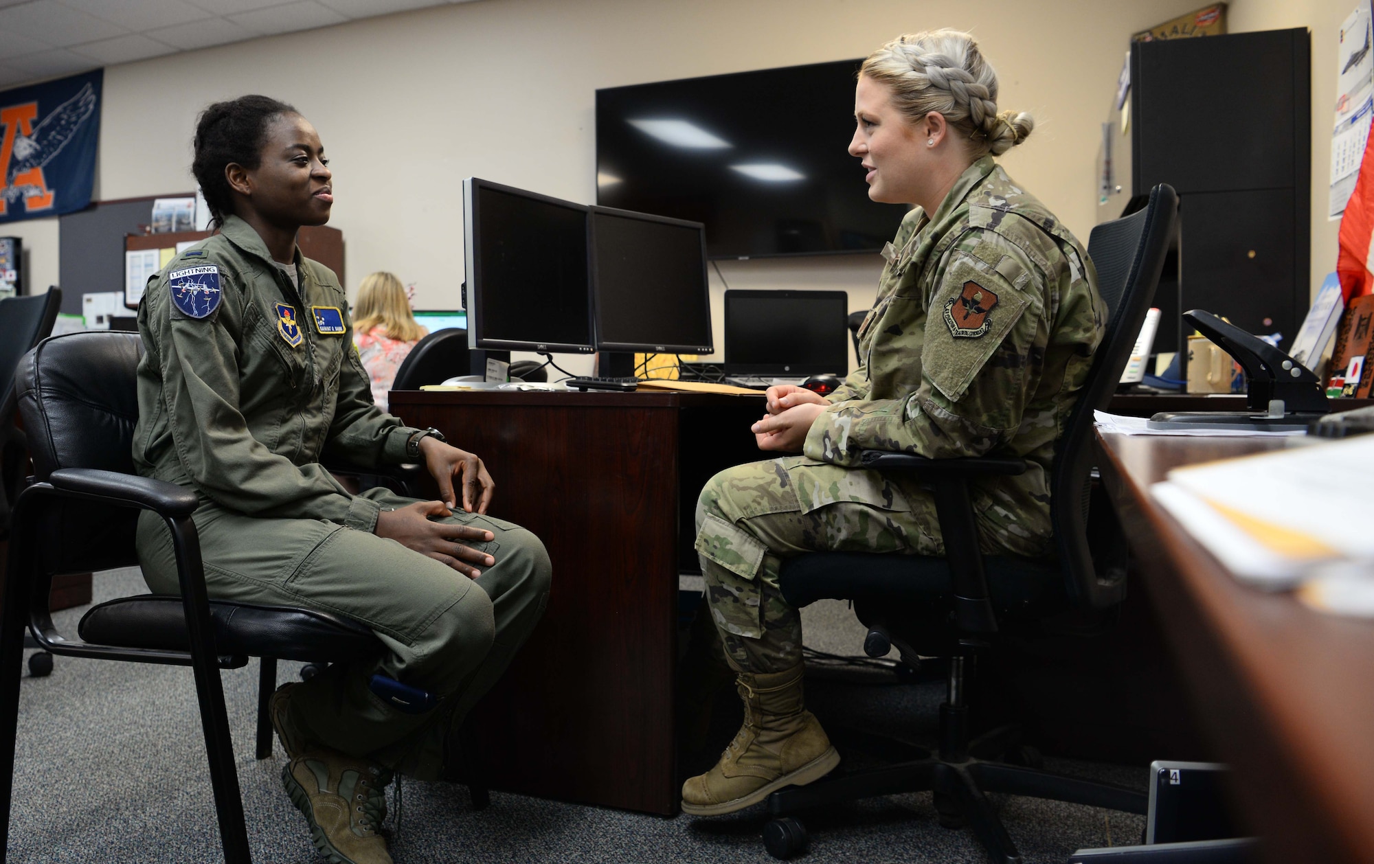 Capt. Christy Martin (right), 14th Student Squadron international military student officer, and 1st Lt. Sanni Kafayat (left), a student pilot from Nigeria, discuss Kafayat’s return home July 26, 2019, at Columbus Air Force Base, Mississippi. The IMSO is tasked with managing the administrative part of an international student’s training. (U.S. Air Force photo by Airman 1st Class Jake Jacobsen