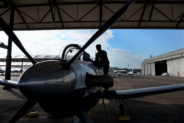 First Lt. Sanni Kafayat, 41st Flying Training Wing student pilot, climbs into the seat of a T-6 Texan II July 26, 2019, at Columbus Air Force Base, Mississippi. Kafayat is a student pilot from Nigeria. (U.S. Air Force photo by Airman 1st Class Jake Jacobsen)