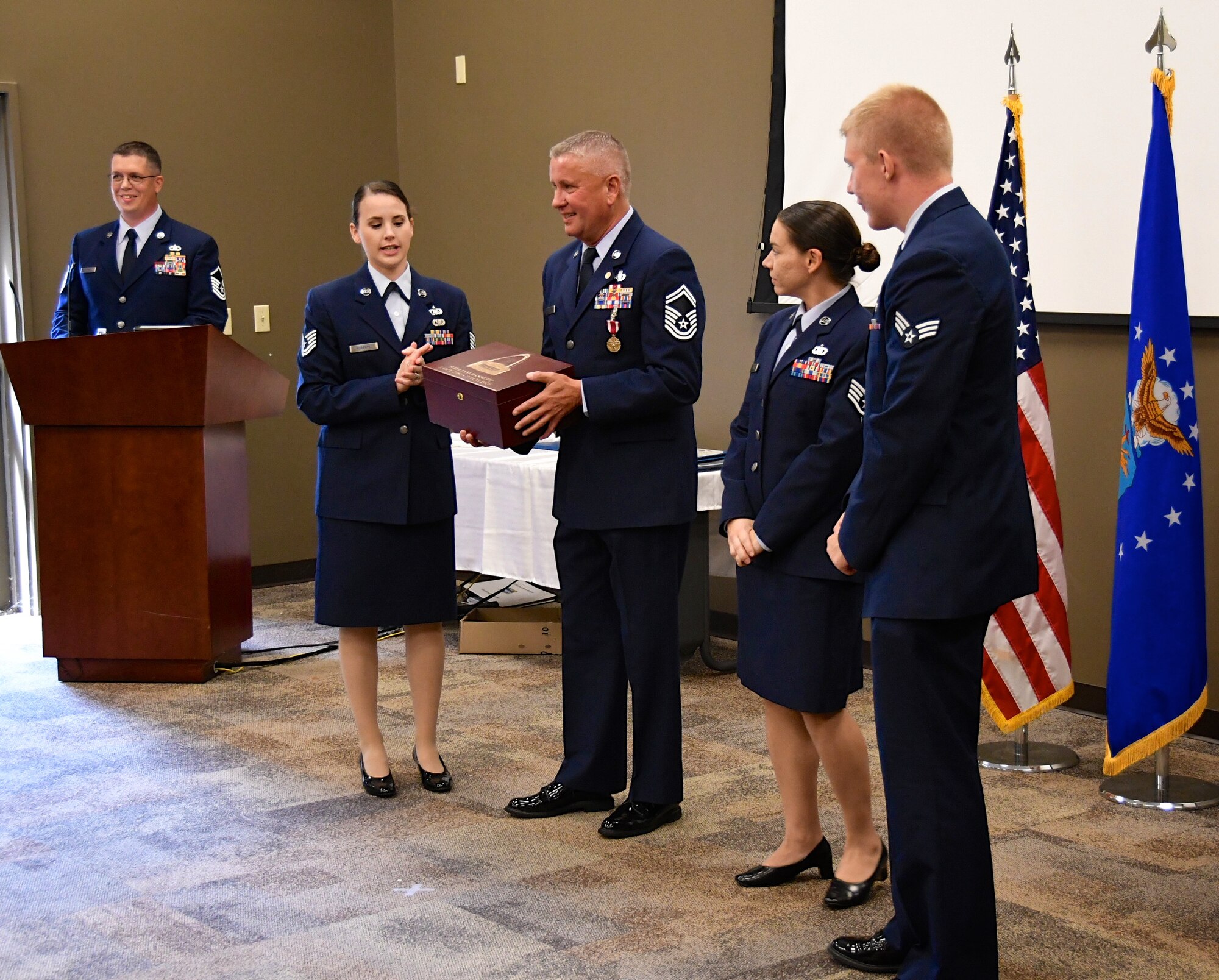 Team members of the Scott Air Force Base Command Post presented a departing gift to their outgoing superintendent.  Senior Master Sgt. William Bassett retired from the 932nd Airlift Wing in a ceremony held August 4, 2019 at Scott Air Force Base, Ill.  (U.S. Air Force photo by Lt. Col. Stan Paregien)