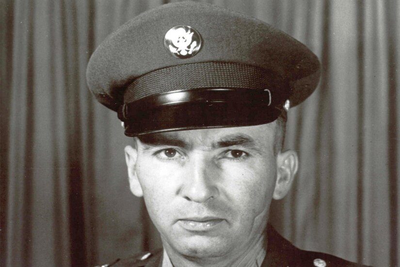 A soldier in his dress uniform and cap wears a Medal of Honor around his neck.
