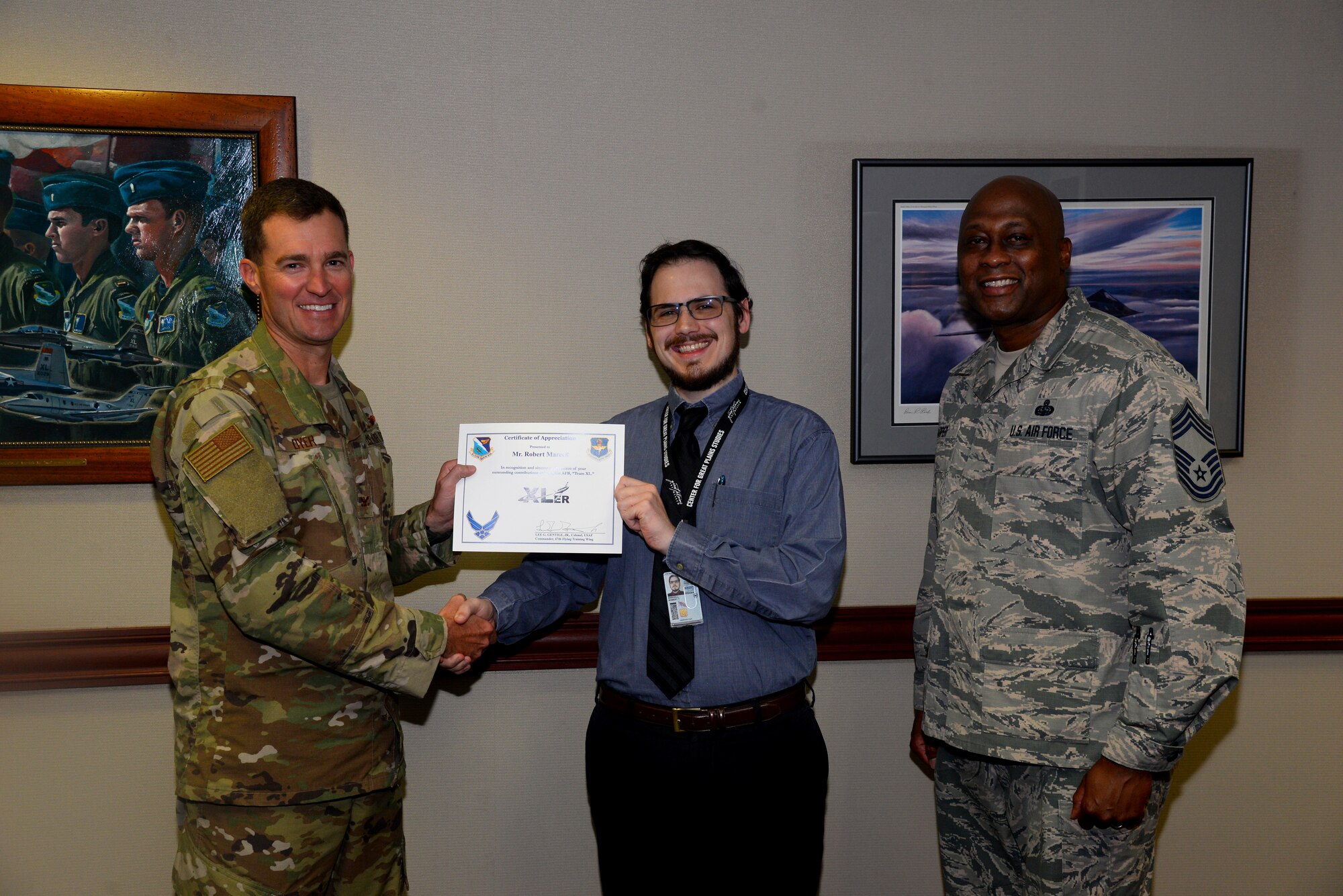 Robert Marcell, the 47th Flying Training Wing historian, was chosen by wing leadership to be the “XLer of the week” for the week of August 5, 2019 at Laughlin Air Force Base, Texas. The “XLer of the Week” award, presented by Col. Todd Dyer, the 47th Flying Training Wing vice commander, and Chief Master Sgt. Ronald Harper, the 47 Mission Support Group superintendent, is given to those who consistently make outstanding contributions to their unit and the Laughlin mission. (U.S. Air Force photo by Senior Airman John A. Crawford)