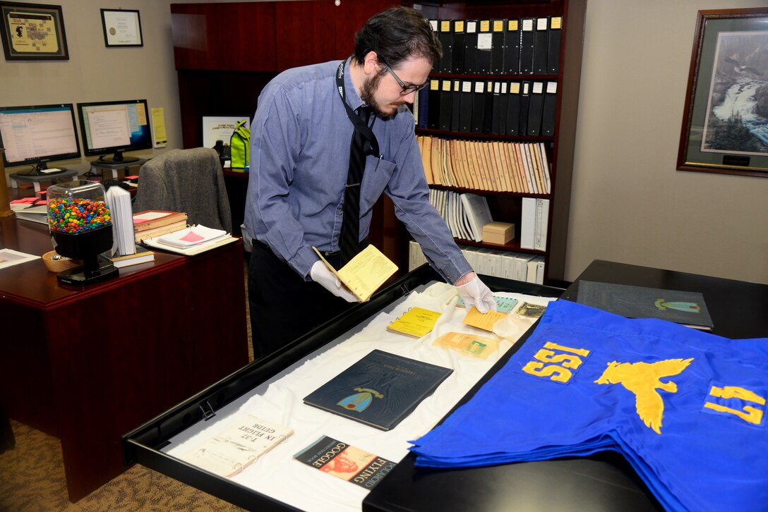 Robert Marcell, the 47th Flying Training Wing historian, examines historical T-33 Shooting Star and T-37B Tweet aircrew checklists at August 5, 2019 at Laughlin Air Force Base, Texas. Marcell has served as the 47th FTW historian since February 2019. (U.S. Air Force photo by Senior Airman John A. Crawford)