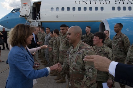 Nancy Pelosi, Speaker of the House of U.S. Representatives, gives a coin to U.S. Army Maj. Matthew Acosta, Joint Task Force - Bravo Future Operations chief, Aug. 10, 2019, at Soto Cano Air Base, Honduras. Representatives from various states visited service members during a visit to Honduras, accompanying the Speaker of the House Nancy Pelosi. (U.S. Air Force photo by Staff Sgt. Eric Summers. Jr.)