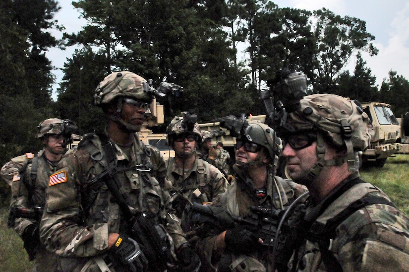 Florida National Guard Soldiers prepare and converse before moving onto lanes training at eXportable Combat Training Capability 19-05 at Camp Shelby, Mississippi.