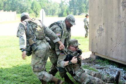 Florida National Guard Soldiers drag a mock casualty to a casualty collection point during lanes training at eXportable Combat Training Capability 19-05 at Camp Shelby, Mississippi.