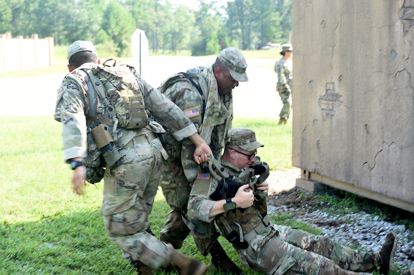 Florida National Guard Soldiers drag a mock casualty to a casualty collection point during lanes training at eXportable Combat Training Capability 19-05 at Camp Shelby, Mississippi.