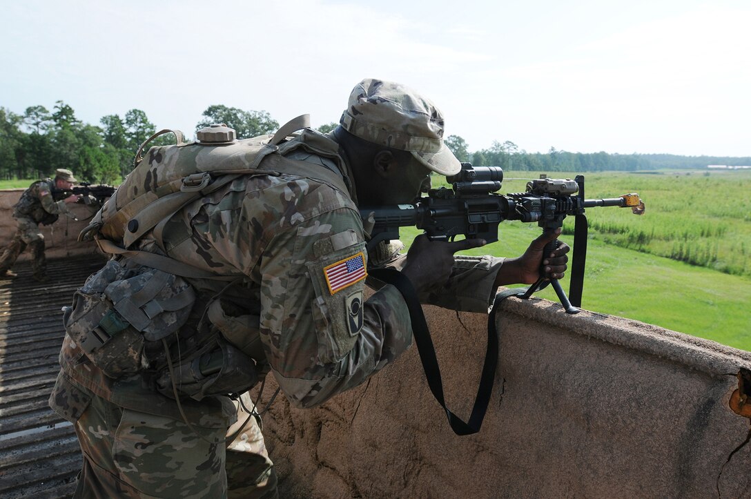 Florida National Guard Soldiers fire at the enemy, from a rooftop building, during lanes training at eXportable Combat Training Capability 19-05 at Camp Shelby, Mississippi.