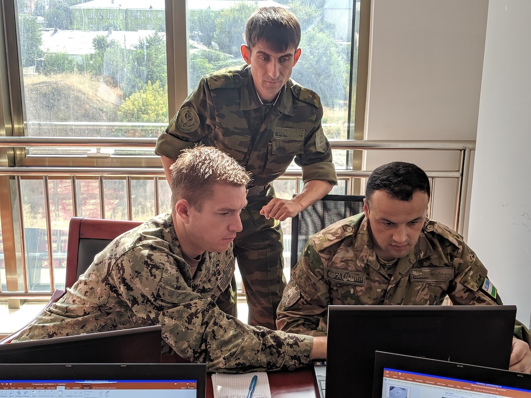 U.S. Navy Lt. Cmdr. Andrew Learned, left, special operations planner for Exercise Regional Cooperation 2019 (RC), attached to Special Operations Command Central; Tajikistan Army Col. Mehriddin Tolibzoda, center, communications officer for RC19; and Uzbekistan Army Maj. Abror Kurbanov, right, special operations engineer for RC19, collaborate on a mission plan for a fictional scenario during RC19 in Dushanbe, Tajikistan, August 13, 2019. Exercise Regional Cooperation is an annual, multinational event that promotes cooperation and interoperability among participating nations to foster security and stability in the Central and South Asian region. The participants of RC 19 include military leaders and officials from Mongolia, Tajikistan, United States and Uzbekistan and observers from Pakistan.

(U.S. Army Reserve photo by Sgt. Jennifer Shick)
