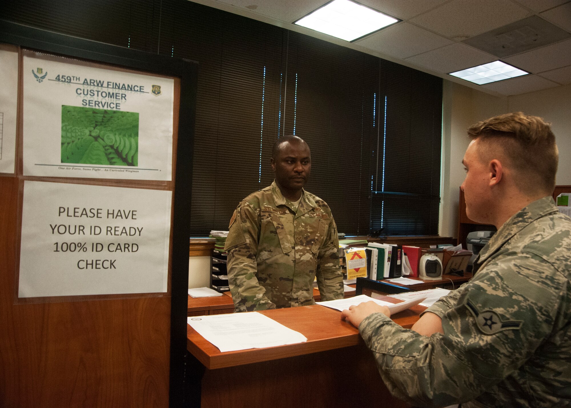 Senior Airman Marcus Sylvester, 459th Air Refueling Wing Financial Management Office military pay specialist, helps Airman Tyler Wolfrey from the 459th Aircraft Maintenance Squadron, with military pay questions Aug. 12, 2019, at Joint Base Andrews, Md. Sylvester is the only unformed service member currently working daily in finance servicing at total of 1,300 Airmen and their families. (U.S. Air Force photo by Staff Sgt. Cierra Presentado/Released)