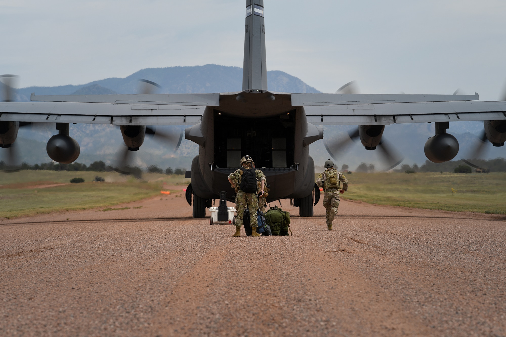 Airmen from the 13th Air Support Operations Squadron practice a contingency landing during mission qualification training July 17, 2019 on Fort Carson, Colorado. The group of Airmen were shuttled by a C-130 Hercules from the 302nd Airlift Wing on Peterson Air Force Base, Colorado. The C-130 was carrying a Humvee, the group of Airmen and all the equipment for their training.  (U.S. Air Force photo by Airman 1st Class Andrew Bertain)
