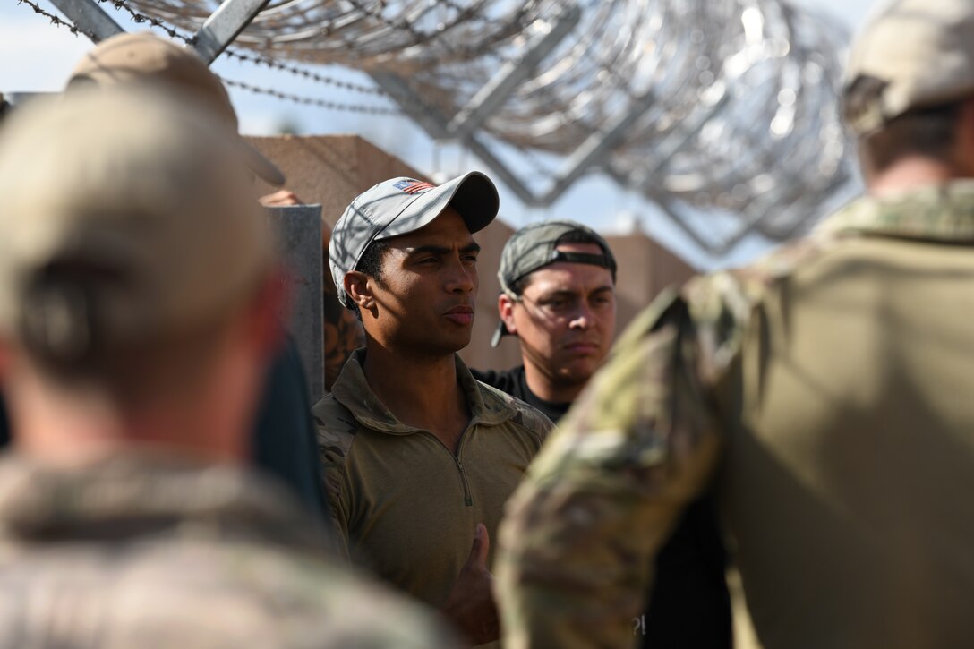 Staff Sgt. Luis Maldonado, left, 13th Air Support Operations Squadron tactical air control party journeyman, briefs instructors before they help the new Airmen in mission qualification training July 17, 2019 on Fort Carson, Colorado. In the exercise, the instructors played multiple roles to assist with the MQT, such as leading the team of students, playing as the opposing force, setting up the event or just overseeing it. (U.S. Air Force photo by Airman 1st Class Andrew Bertain)