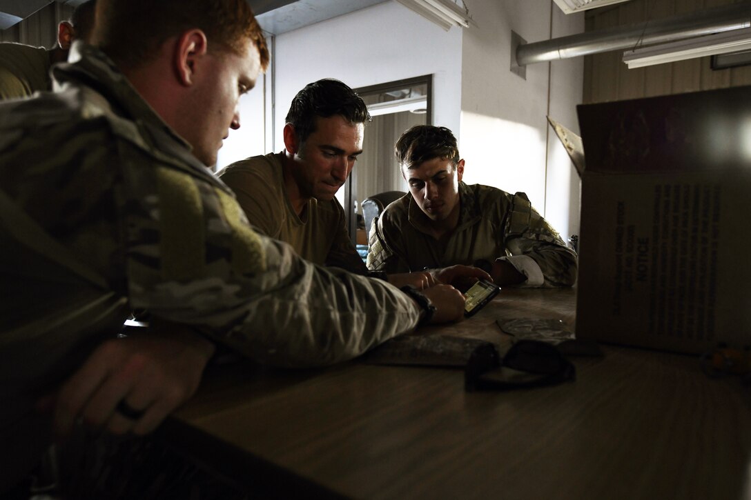 Senior Airman Jake Cook, left, 2nd Lt. Tyler Johnson and Senior Airman James Adams, Airmen from the 13th Air Support Operations Squadron, plan their route of attack in the squadron’s mission qualification training July 17, 2019 on Fort Carson, Colorado. In the exercise, many of the instructors role played as the opposing force against the students. (U.S. Air Force photo by Airman 1st Class Andrew Bertain)