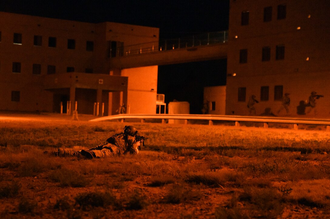 Tactical air control party Airmen from the 13th Air Support secure a village during mission qualification training July 17, 2019 on Fort Carson, Colorado. The Airmen started the exercise by getting dropped off by a helicopter and then had to make their way through the village with the end goal being to take control with maximum efficiency and minimum casualties.  (U.S. Air Force photo by Airman 1st Class Andrew Bertain)