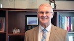 Deputy director stands in his office.