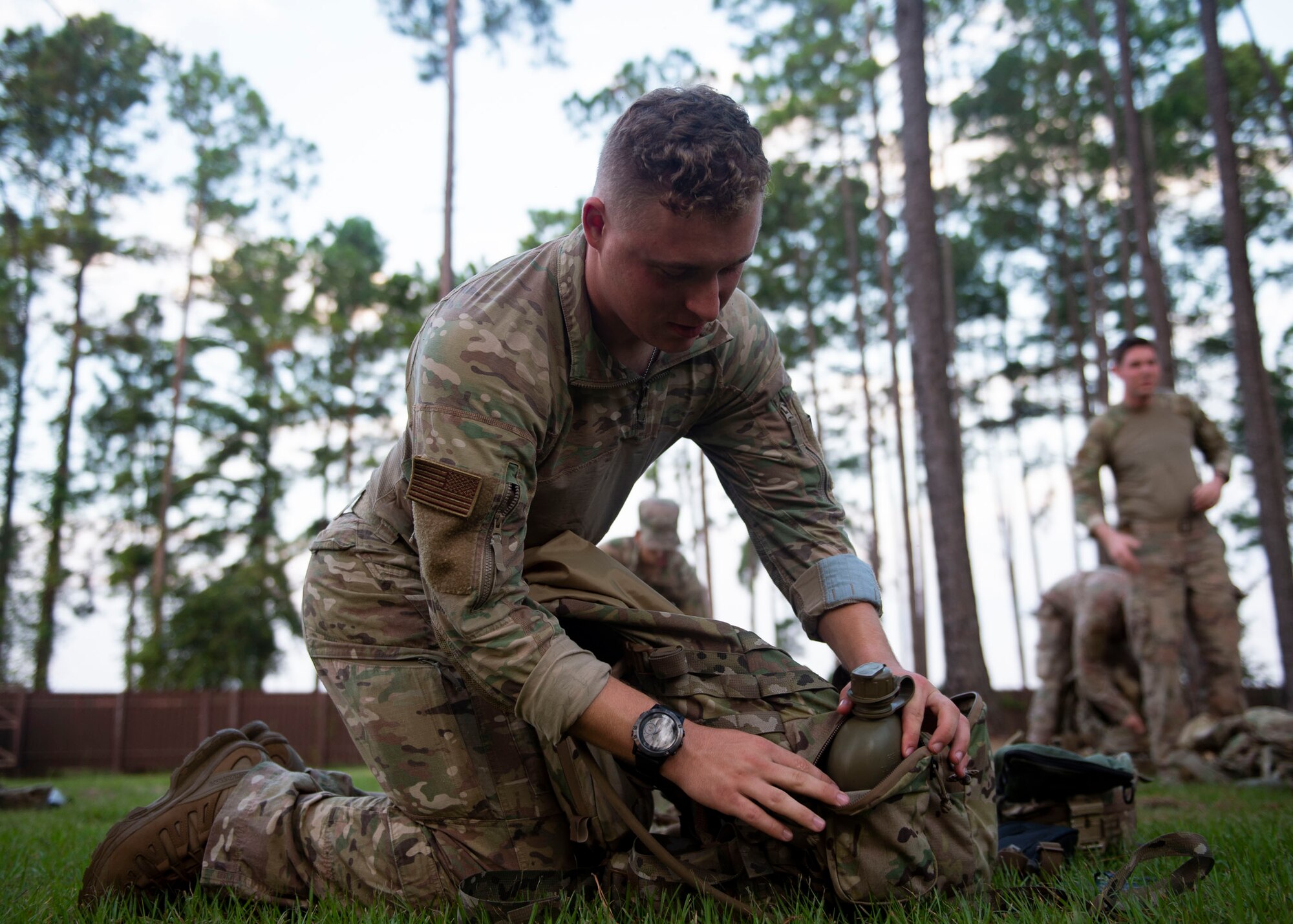 Airman 1st Class Elijah Weiner, 824th Base Defense Squadron fire team member, unpacks a bag during the Tactical Leaders Course, Aug. 10, 2019, at Moody Air Force Base, Ga. The 7-dayTactical Leaders Course revolved around squad leaders developing their skills to effectively communicate, team build and mission plan. These skills were assessed during a 36-hour simulated operation where squad leaders lead Airmen through tactical situations. (U.S. Air Force photo by Airman Azaria E. Foster)