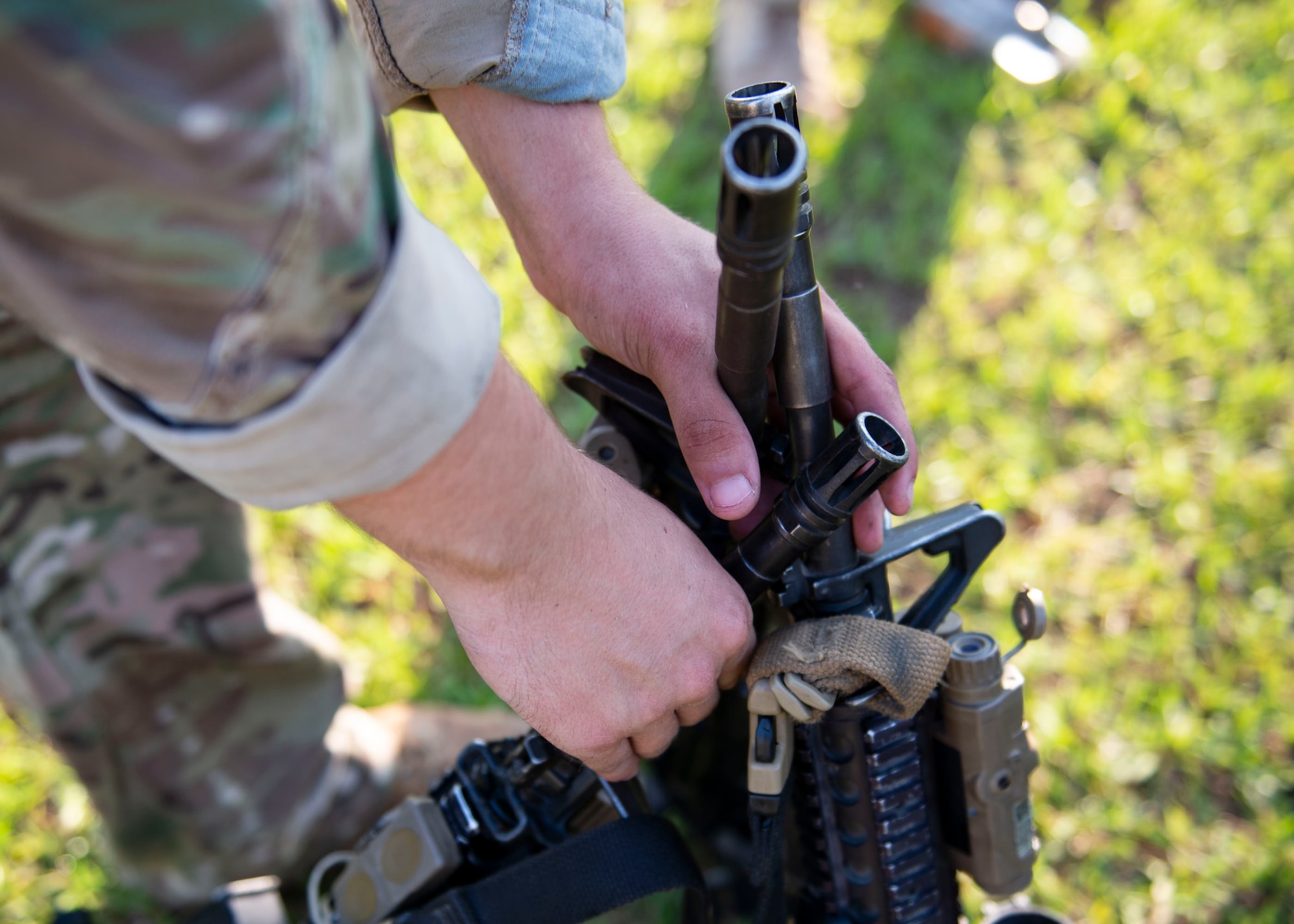 An Airman from the 824th Base Defense Squadron stacks weapons during the Tactical Leaders Course, Aug. 10, 2019, at Moody Air Force Base, Ga. The 7-day course revolved around squad leaders developing their skills to effectively communicate, team build and mission plan. These skills were assessed during a 36-hour simulated operation where squad leaders lead Airmen through tactical situations.  (U.S. Air Force photo by Airman Azaria E. Foster)