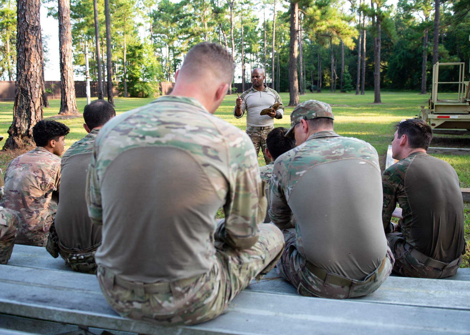 Tech. Sgt. Justin Amburgey, 824th Base Defense Squadron squad leader briefs Airmen on the training plan during the Tactical Leaders Course, Aug. 10, 2019, at Moody Air Force Base, Ga. The 7-day course revolved around squad leaders developing their skills to effectively communicate, team build and mission plan. These skills were assessed during a 36-hour simulated operation where squad leaders lead Airmen through tactical situations. (U.S. Air Force photo by Airman Azaria E. Foster)