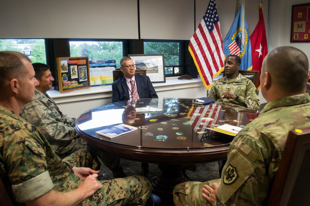Marine Corps Col. Larry Herring, left front, and Air Force Col. John Gustafson, left rear, the DLA Aviation Richmond Marine Corps and Air Force Customer Facing Division chiefs, respectively, meet with Richard Ellis, rear center, DLA Troop Support Deputy Commander, Army Brig. Gen. Gavin Lawrence, rear right, DLA Troop Support Commander, and Air Force Col. Adrian Crowley, Industrial Hardware director, to discuss the role DLA Troop Support plays in supporting the Warfighter in Philadelphia Aug. 14, 2019.