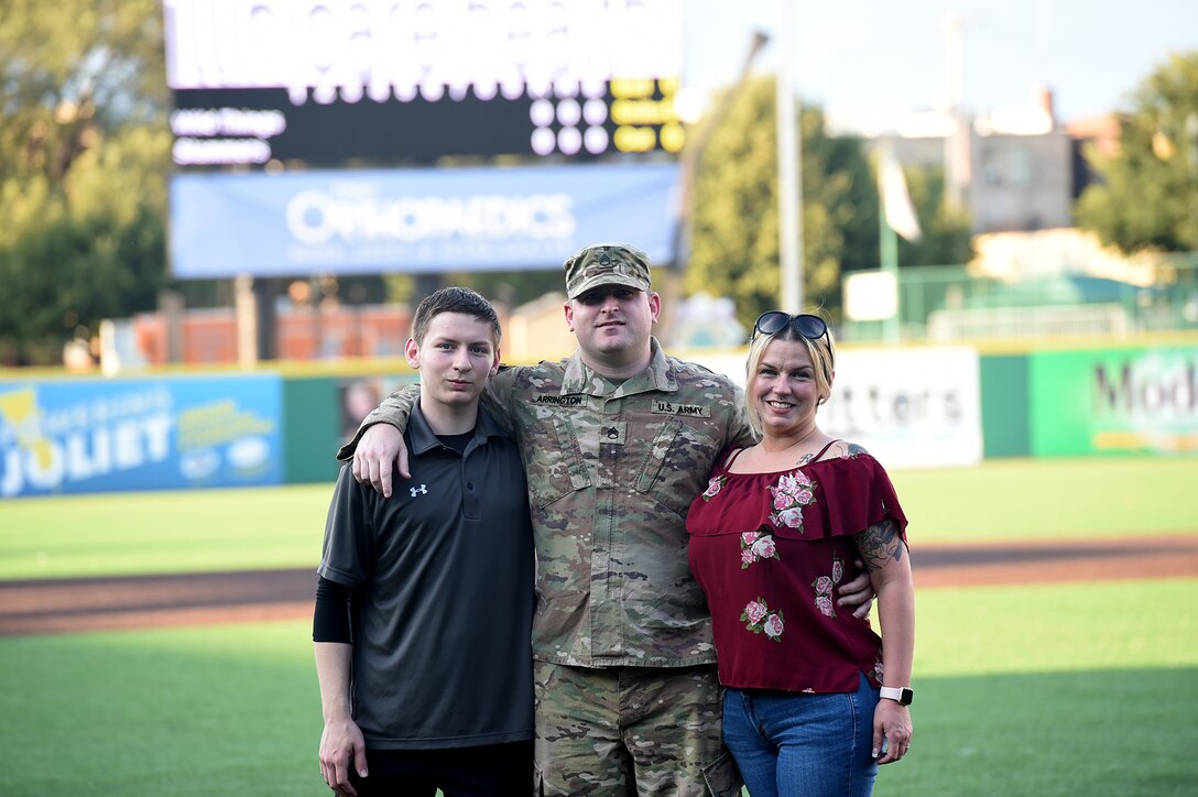 Army Reserve Staff Sgt. Clifford Arrington, Information Systems noncommissioned officer assigned to the 85th U.S. Army Reserve Support Command, pauses for a photo with his family before a Joliet Slammers home game, August 13, 2019 in Joliet, Illinois.