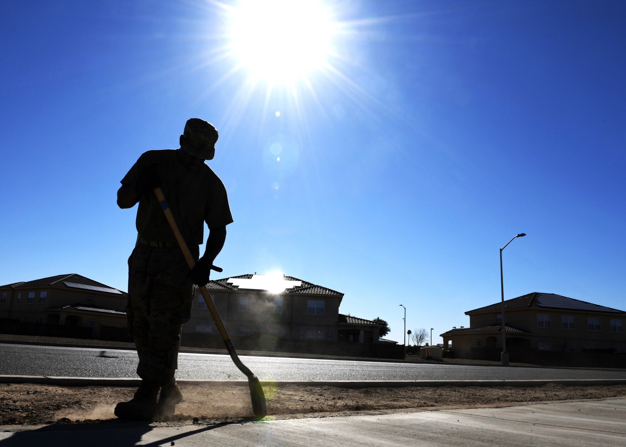 Tech. Sgt. Aaron Jones, 56th Civil Engineering Squadron pavements and heavy equipment operator, shovels dirt Aug. 12, 2019, at Luke Air Force Base, Ariz.