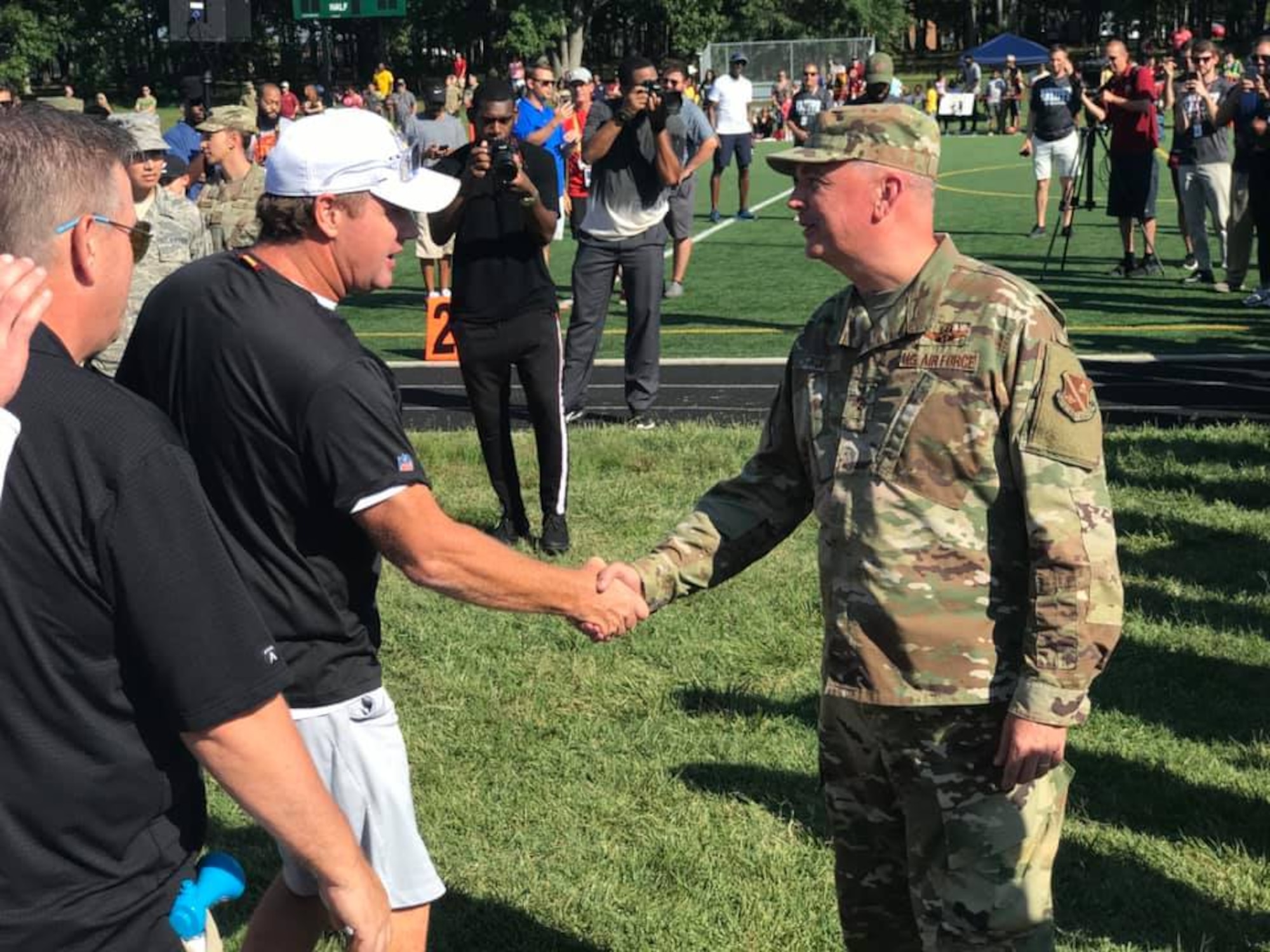 Air Force District of Washington Commander Maj. Gen. Ricky N. Rupp shakes hands with Washington Redskins head coach Jay Gruden during the team's walkthough practice here at Joint Base Andrews Aug. 14. The event is part of the NFL team's ongoingRedskins Salutes efforts presented by USAA. (U.S. Air Force/Lt. Col. John Ross)