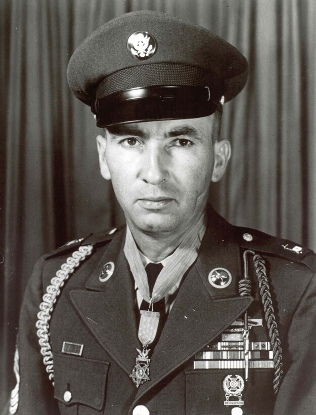 A soldier in his dress uniform and cap wears a Medal of Honor around his neck.