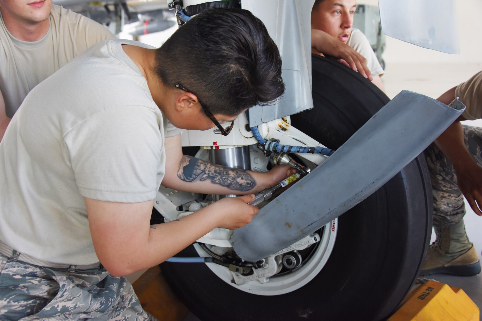 Airman removes lower torque arm bearing of an A-10 at Sheppard AFB.