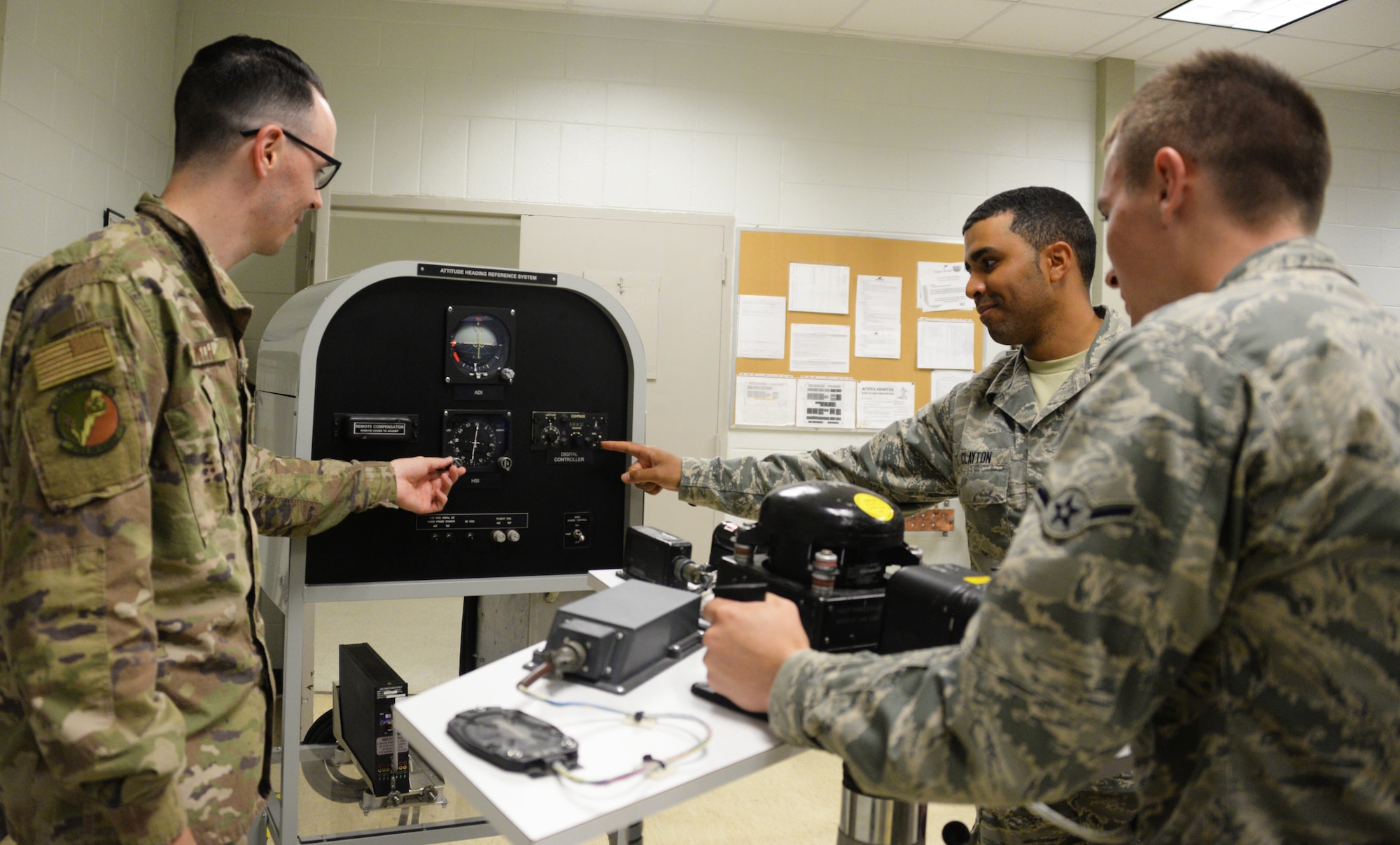 365th Training Squadron instructor and students review a basic navigation system at Sheppard AFB
