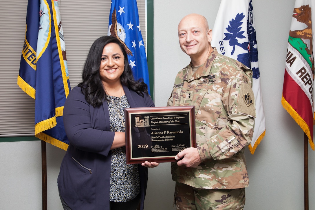 Maj. Gen. Anthony Funkhouser, USACE Deputy Commanding General for Military and International Operations, presents Arianna Raymundo, Sacramento District Army/Air Force section chief, with the 2019 USACE Project Manager of the Year Award.