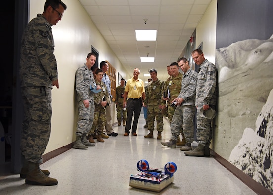 U.S. Air Force personnel from The National Air and Space Intelligence Center observe a hovercraft made by 312th Training Squadron students from scrap and 3-D printed parts on Goodfellow Air Force Base, Texas, August 13, 2019. Students are challenged to think outside the box and break things to improve and create other things. (U.S. Air Force photo by Airman 1st Class Ethan Sherwood/Released)