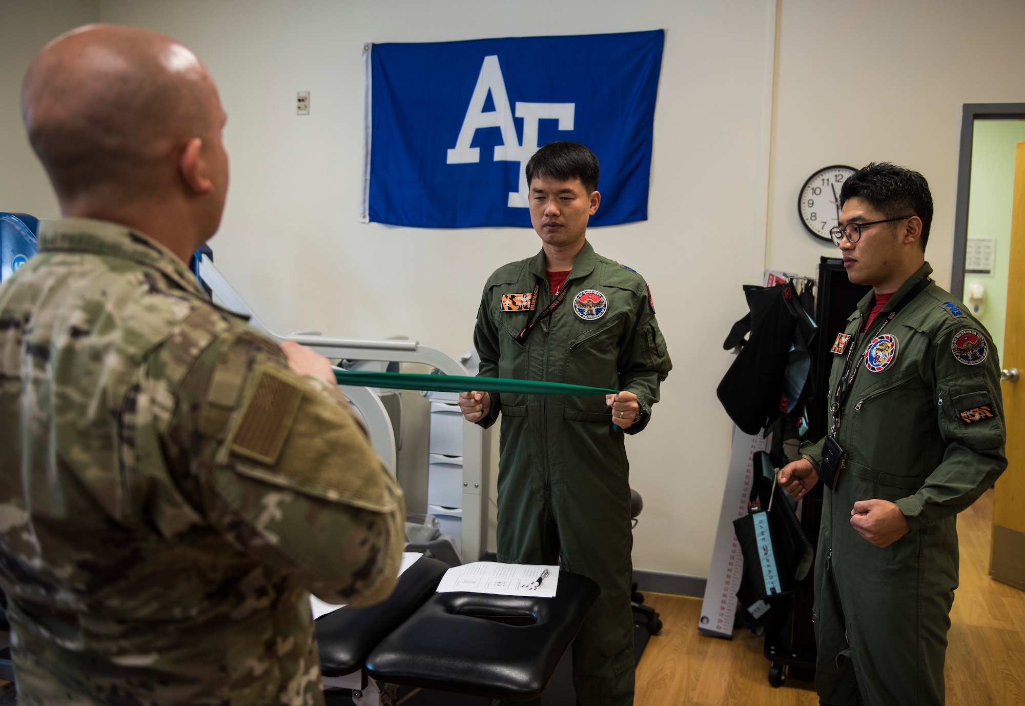 U.S. Air Force Tech. Sgt. Nicholas Ramirez, 8th Medical Operations Squadron physical therapy flight chief, teaches pilots from Republic of Korea Air Force’s 111th Fighter Squadron how to stretch their backs, during a training session at Kunsan Air Base, Republic of Korea, Aug. 9, 2019. Pilots often find themselves developing pain in different areas from regularly putting their bodies under high amounts of gravitational forces. (U.S. Air Force photo by Senior Airman Stefan Alvarez)