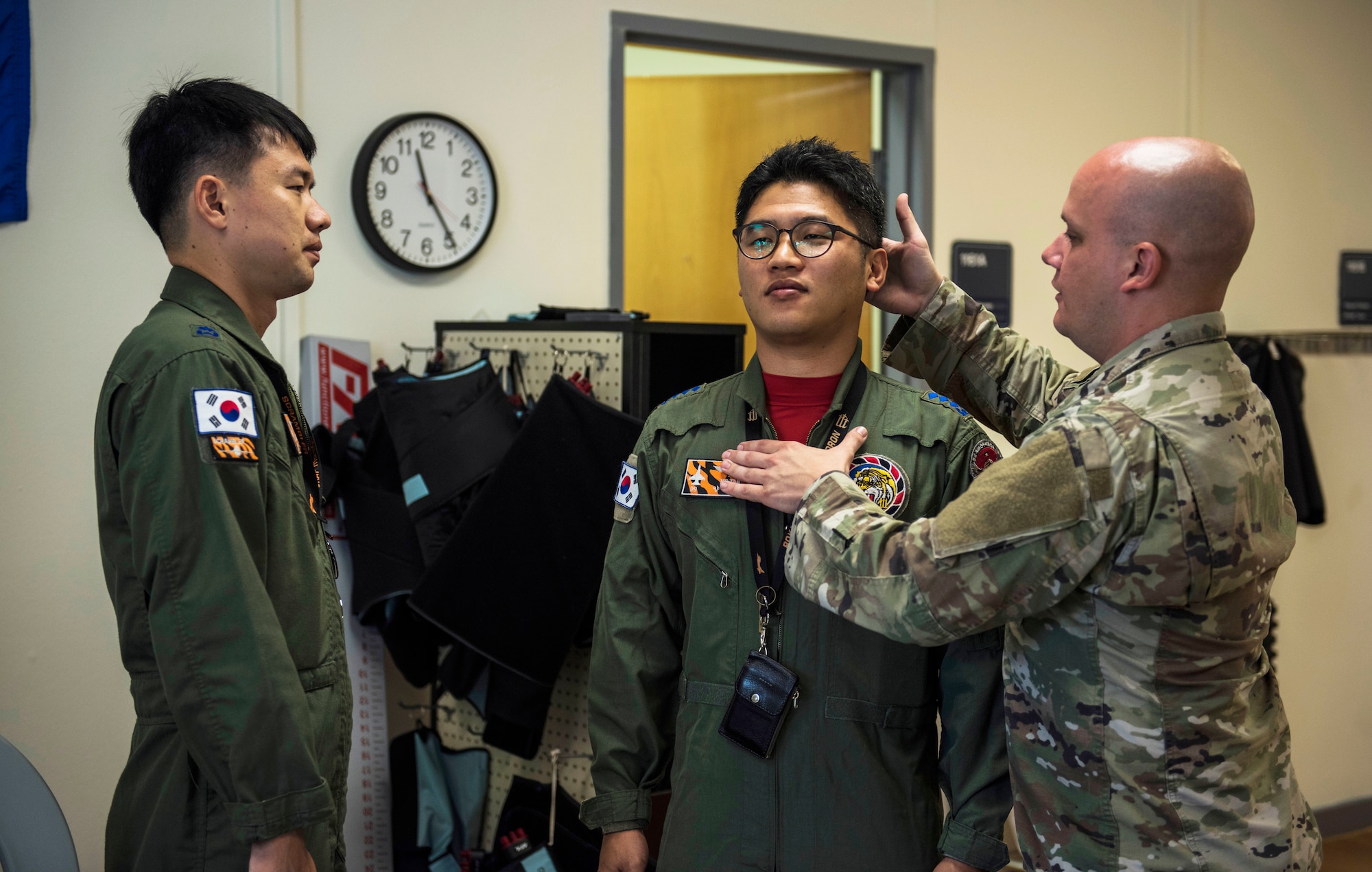 U.S. Air Force Tech. Sgt. Nicholas Ramirez, 8th Medical Operations Squadron physical therapy flight chief, teaches pilots from Republic of Korea Air Force’s 111th Fighter Squadron how to adjust their posture during a training session at Kunsan Air Base, Republic of Korea, Aug. 9, 2019. Pilots often suffer from neck and back pain from flying for prolonged hours wearing their equipment. (U.S. Air Force photo by Senior Airman Stefan Alvarez)