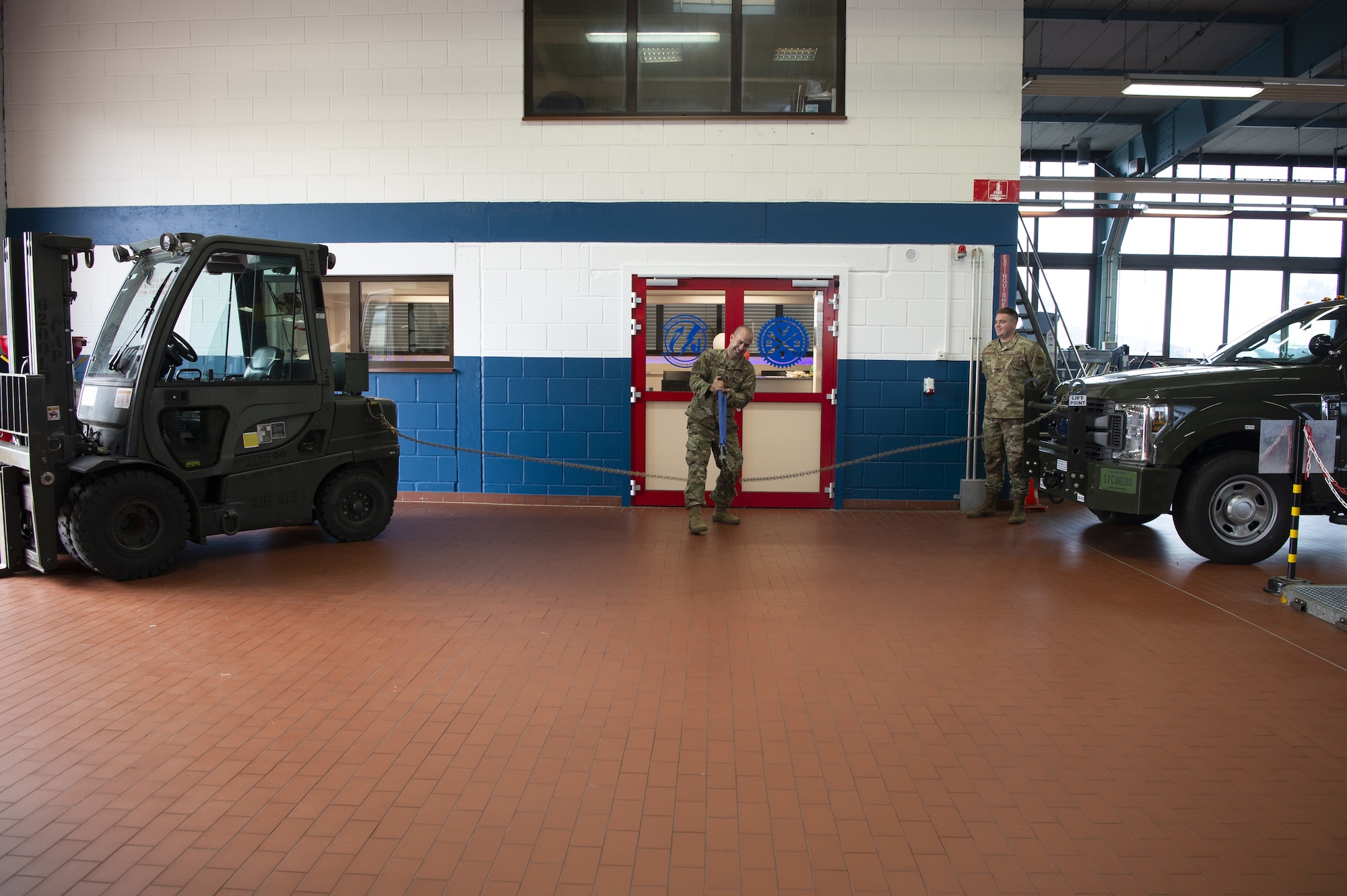 U.S. Air Force Major Juan Fial, 52nd Logistics Readiness Squadron commander, cuts chain links to re-open the newly renovated 52nd LRS Vehicle Management Flight customer service center at Spangdahlem Air Base, Germany, July 31, 2019.