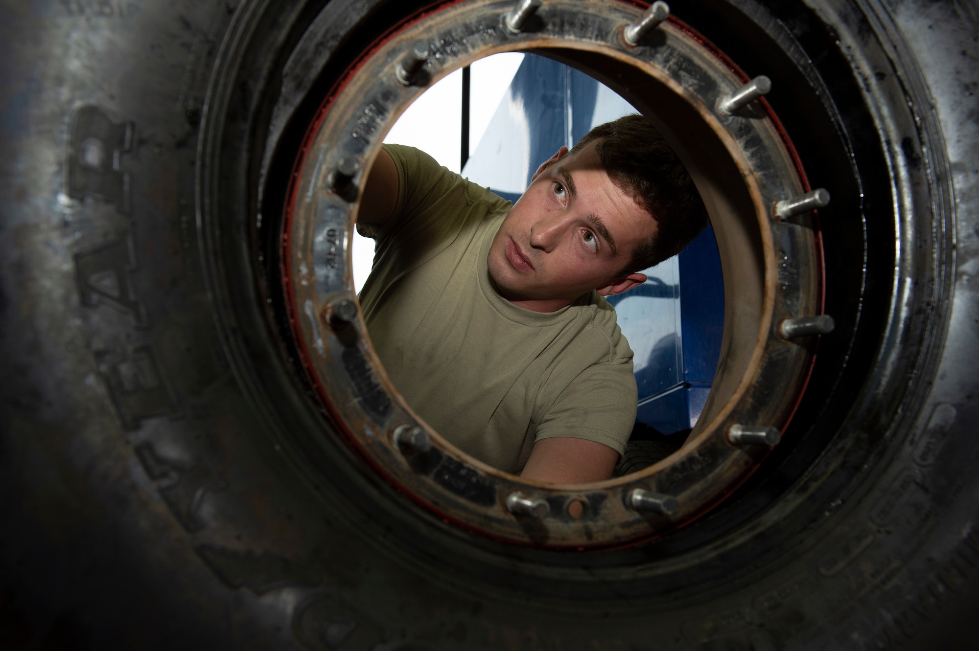 U.S. Air Force Airman 1st Class Colin Coogan, 52nd Logistics Readiness Squadron vehicle maintenance journeyman, performs, an inspection on a tire at Spangdadhlem Air Base, Germany, Aug. 7, 2019.