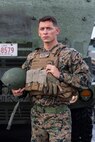 U.S. Marine Cpl. Pablo Villegas, a M142 High Mobility Artillery Rocket System operator with 3rd Battalion, 12th Marine Regiment, 3rd Marine Division, poses for a photo in front of a HIMARS launcher during a simulated amphibious raid, at Kin Blue, Okinawa, Japan, Aug. 14, 2019. “This [training] helps showcase our unit’s mobility and the mobility of the HIMARS in the Indo-Pacific.” said Villegas. This simulated amphibious raid marks the first time that HIMARS have been inserted by landing craft, utility, demonstrating the Marine Air-Ground Task Force’s ability to conduct combined-arms maneuver from amphibious shipping. Villegas is a native of Oceanside, Calif. (U.S. Marine Corps photo by Lance Cpl. Joshua Sechser)