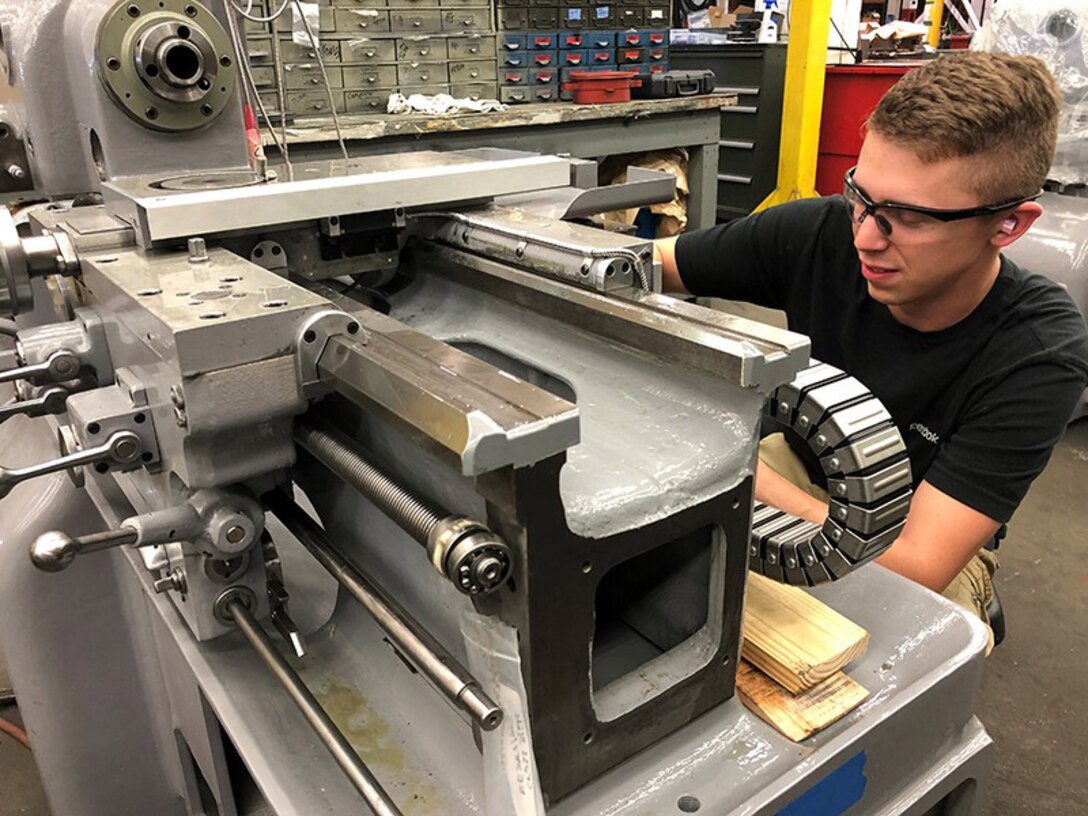 Mechanic Kristopher Nace refurbishes a Lathe